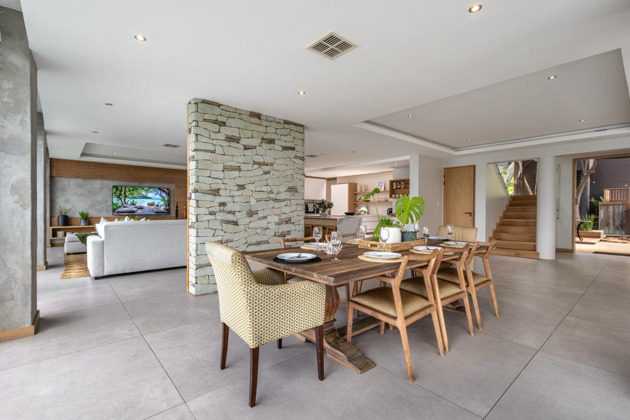 Whitefoord Beach House dining room with stone column