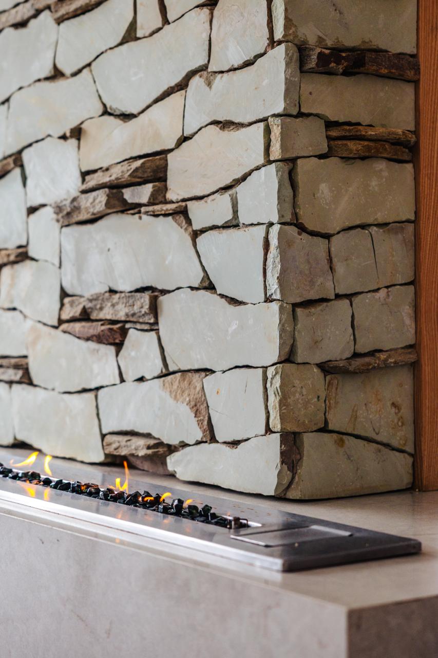 Whitefoord Beach House fireplace with stacked stone detail